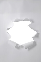 a sheet of paper with a torn hole in the middle in the form of a frame, isolated on a white background