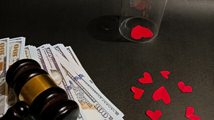 A symbolic image showing a judge’s gavel, dollar bills, and red heart shapes, representing the balance between love, money, and justice in relationships, divorce, or emotional decisions.