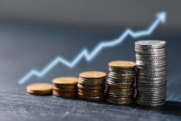 stack of coins and financial growth chart, business investment concept, macro detail