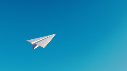 Paper airplane soaring overhead in a clear blue sky, symbolizing travel and new ideas with copy space