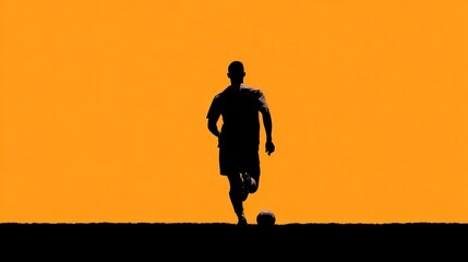 Silhouette of a soccer player running towards a ball on a vibrant orange background during sunset