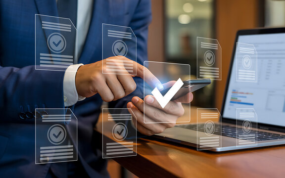 Businessman uses smartphone with digital verification icons and laptop