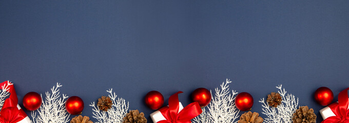 Merry Christmas and Happy New Year greeting card, frame, and banner. Holidays design. Noel and Feliz Navidad. Gifts and decorations, top view, flat lay. Text space, copy space winter background.