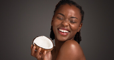 Skincare, coconut and black woman in studio with natural, health and organic facial glow. Happy,...