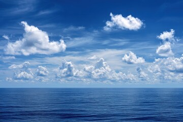 Fototapeta premium Deep blue sea under a sky with dramatic cumulus clouds