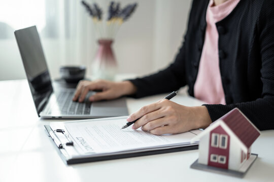 cagents working in real estate investment and home insurance signing contracts in accordance with the home buying insurance agreements approving purchases for clients