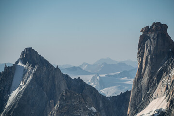 Dramatic rock foundations near the Mont Blanc massif with more alpine mountains in the background in morning light