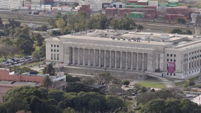 Aerial view of the University of Buenos Aires (UBA) Law School building surrounded by green areas and city streets.