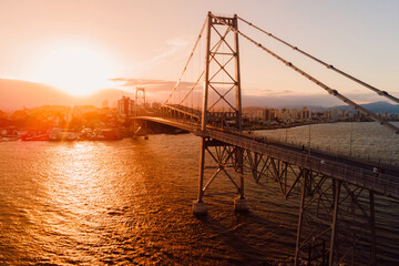 Hercilio luz old bridge with sunset light in Florianopolis city, Brazil. Aerial view © artifirsov