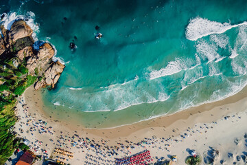 Joaquina beach with rocks and ocean with waves in Brazil. Above view