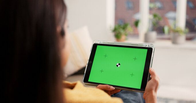 Woman, hands or tablet with green screen in home for advertising, research or marketing app. Back view, female person or user with technology display for online entertainment on mockup space in house