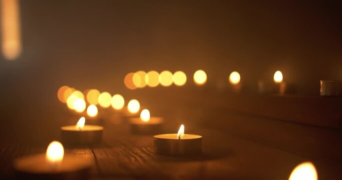 Closeup of Candles and Smoke in Dark Room. Ambient Background for Christianity, religion, prayer room worship background.