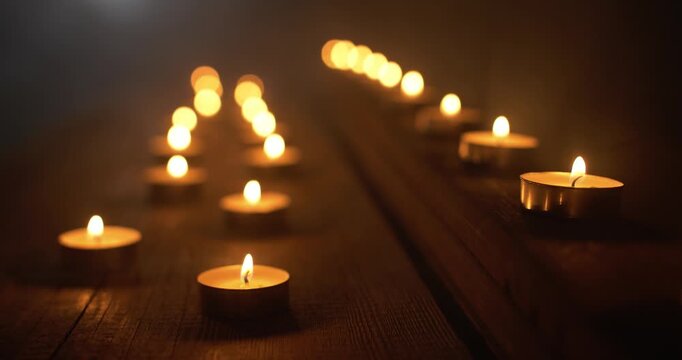 Closeup of Candles and Smoke in Dark Room. Ambient Background for Christianity, religion, prayer room worship background.