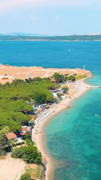 Vertical video. Kilitbahir, Turkey. Aerial drone flight along the coastline of the Dardanelles Strait towards the historic Namazgah Bastion, an Ottoman-era fortification. Aerial View. Rich colors