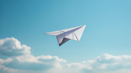 A white paper airplane flying against a clear blue sky with scattered clouds