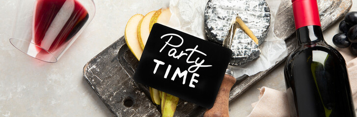 Bottle and glasses of red wine with snacks. Party concept.