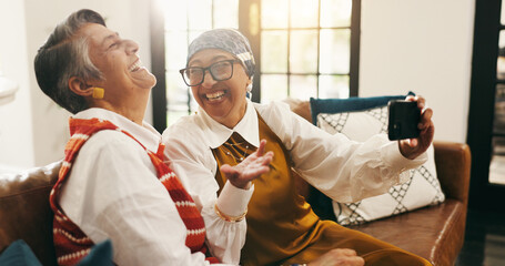 Selfie, laugh and senior women on sofa for memory together on weekend with bonding in home. Happy,...