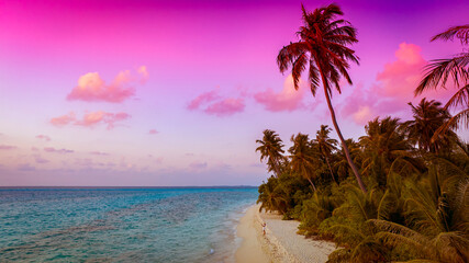 The landscape view of Paradise Island with Pink and Purple Tropical Sunset at Maldivian Dream Beach