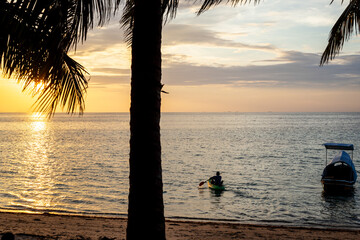 Sunset sea beach with boat on tropical island. Beautiful exotic travel landscape.