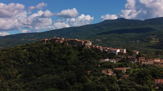 Aerial of Montegiovi, Tuscany with stone houses on a hill overlooking lanscape near Monte Amiata