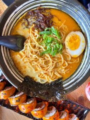 Japanese ramen with rich broth, noodles, egg, and seaweed paired with spicy sushi rolls. A vibrant Asian food scene showcasing authentic flavor, culture, and modern culinary presentation.