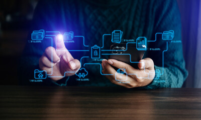 Fototapeta premium Futuristic concept of cybersecurity and cloud data storage. Man using smartphone with virtual interface for digital network, innovation, and online technology.