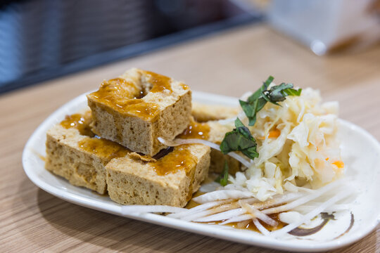 Crispy stinky tofu with pickled cabbage on plate
