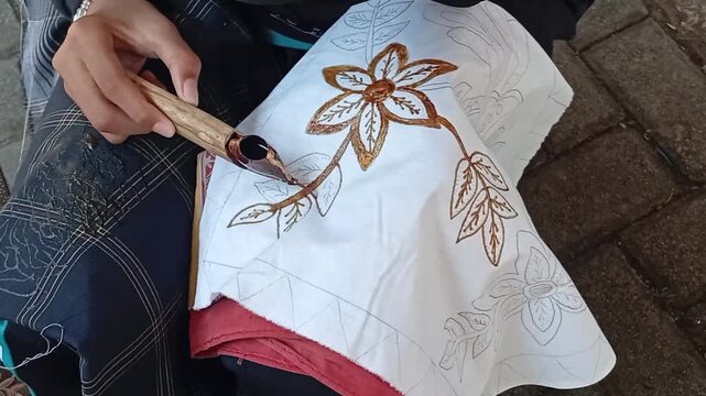 hand girl doing batik cloth