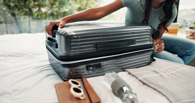 Hands, packing and suitcase with person on bed in home for holiday, travel or vacation. Closing, getting ready and luggage with tourist or traveler in bedroom of apartment for trip preparation