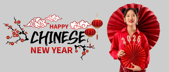 Beautiful Asian woman with paper fans and candles in shape of figure 2026 on grey background