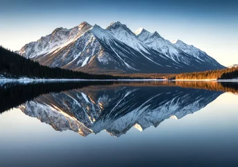 Wanddecoratie Reflectie Snowy mountains reflected on a calm lake under a clear blue sky on a bright sunny winter day scene  © Alice