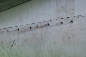 Detail of aircraft fuselage joint with series of screw fasteners and surface wear on a multirole fighter jet
