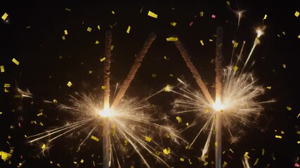 Two bright sparklers burning with golden sparks and falling confetti against a dark background, celebrating a festive occasion. - Powered by Adobe