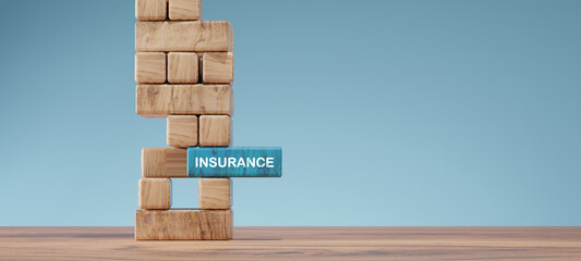 Insurance concept with wooden blocks tower showing risk management and protection. The blue block labeled INSURANCE represents stability, safety, and financial security.