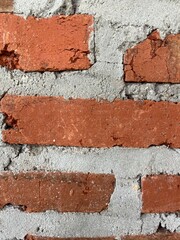 Close-up of red brick wall with gray cement texture