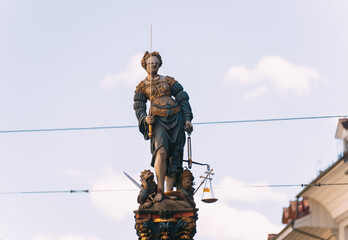Lady justice statue holding sword and scales in bern