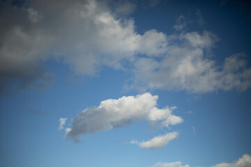 The sky is filled with delicate white clouds, soaring high in the air.