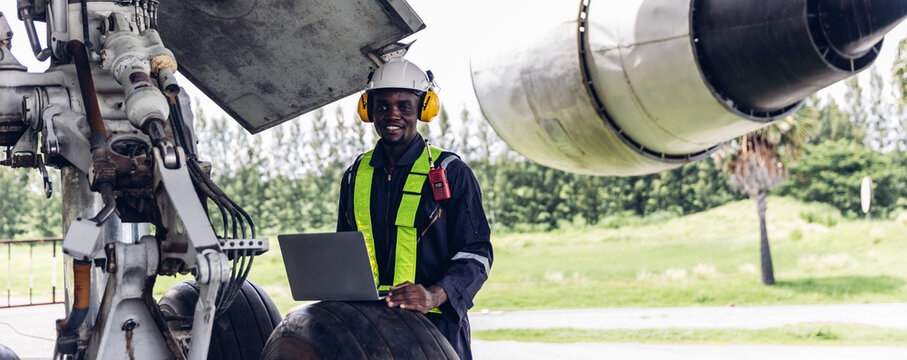 Aircraft workers checking airplane. Ground personnel at the airport check the hydraulic system of the landing gear of the aircraft