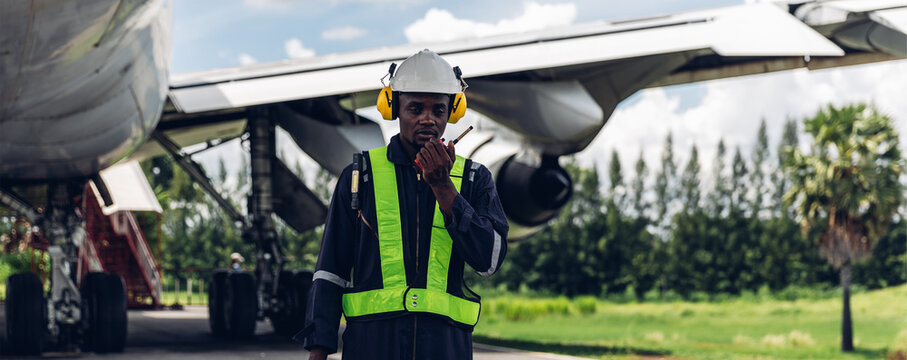 Aircraft workers checking airplane. Ground personnel at the airport check the hydraulic system of the landing gear of the aircraft