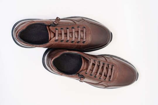 Brown leather shoes on a white background - Powered by Adobe