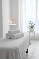 Beautiful spa elements on the massage table in the wellness center. Massage on light wooden background. blur living room, natural creams and moisturizing Healthy lifestyle