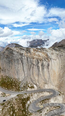 Mountain road winding through alps landscape at Col du Galibier pass, Savoie, Auvergne-Rhone-Alpes, France, Europe.