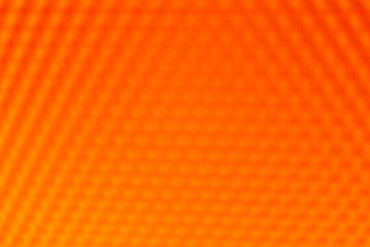 Orange yellow vibrant abstract background. The blurred geometric hexagonal pattern creates a warm, intense, and dynamic texture - Powered by Adobe