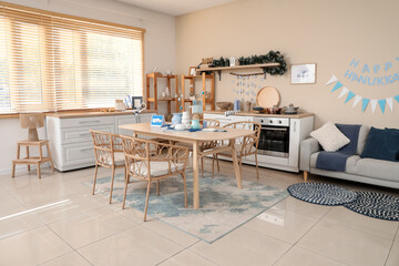 Interior of festive kitchen with served dining table and Hanukkah decorations