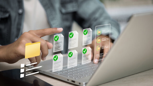 Person using laptop with digital document management and cloud storage system concept