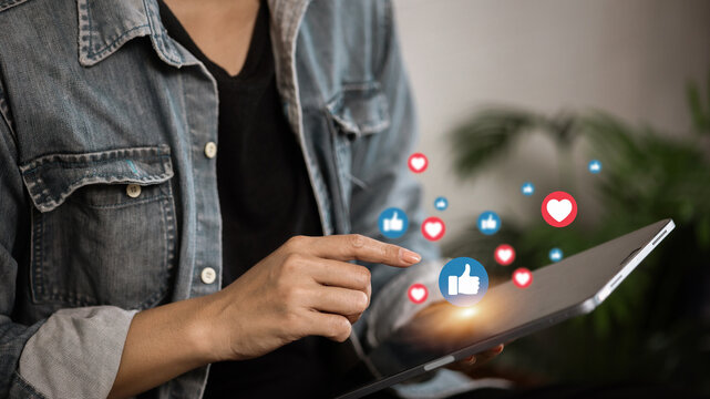 Person using tablet with social media icons floating, digital marketing and online communication concept