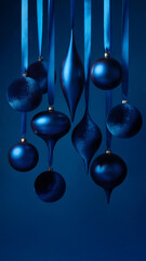 Blue Christmas ornaments hanging on dark blue background. Space for text.