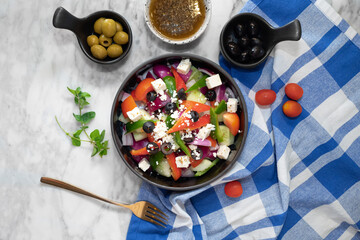 A vibrant and fresh Greek salad with various ingredients arranged artfully