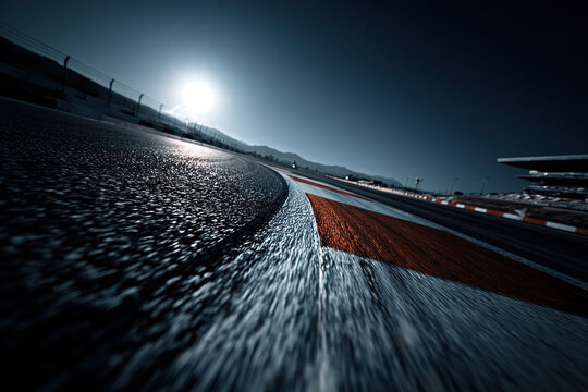 Close-up of red and white curb on race track. - Powered by Adobe