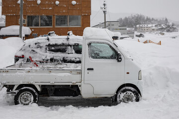 Heavy snowfall buries vehicles rural Japan